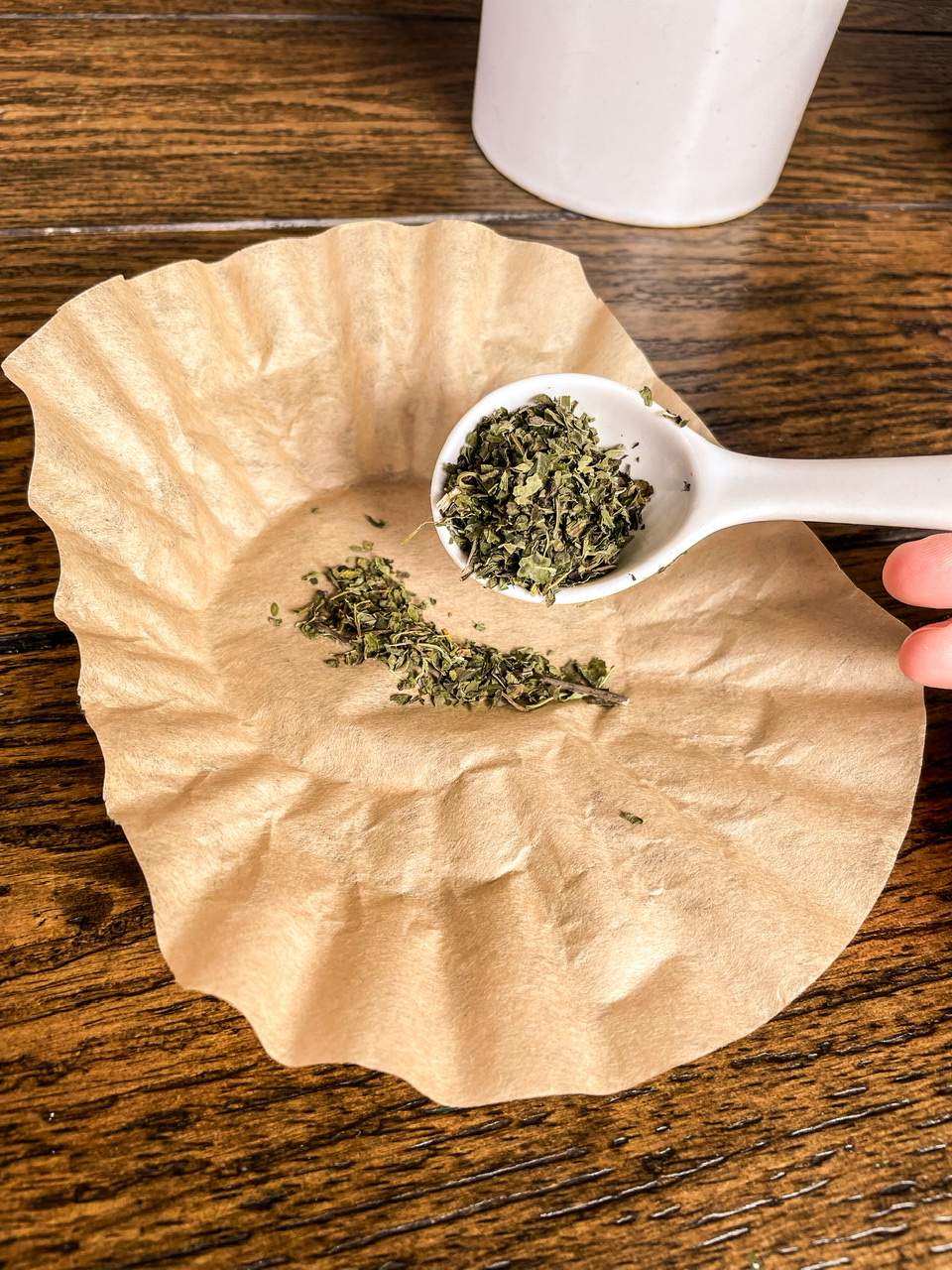 loose leaf tea being put in a coffee filter