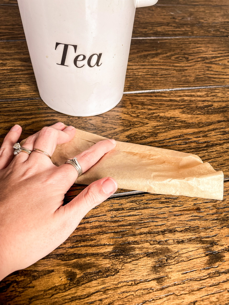 coffee filter being folded with a tea container in the background