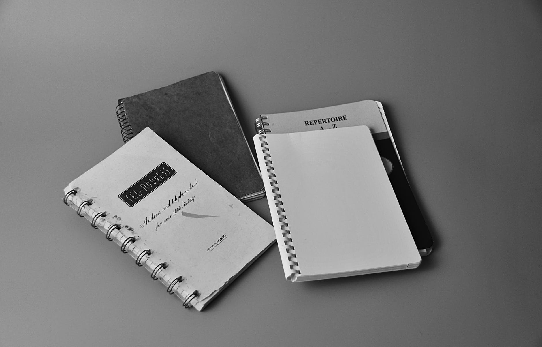 white notebook on white and black book