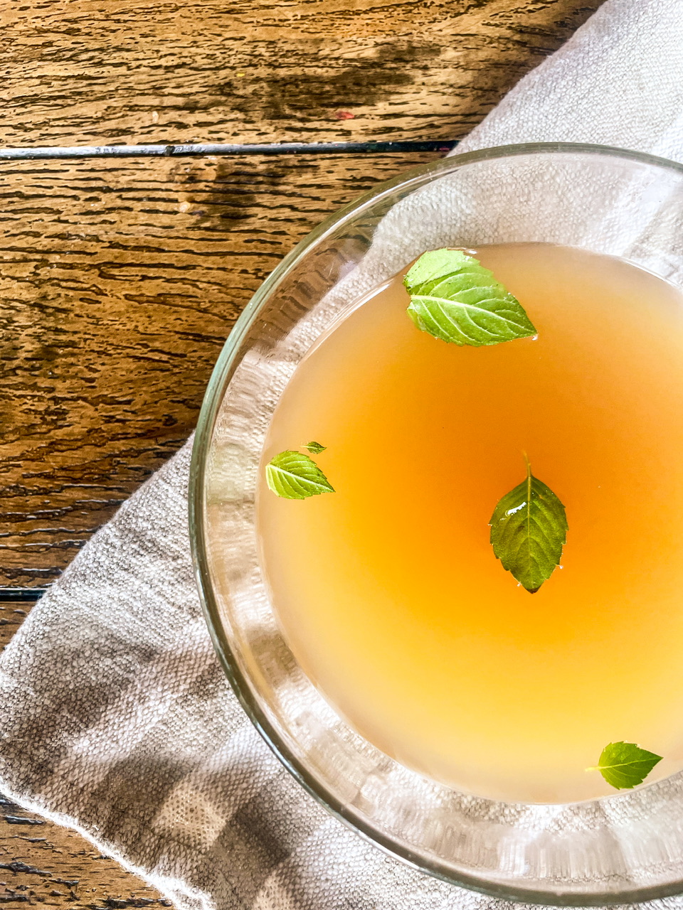 Bowl of bone broth on a dish towel